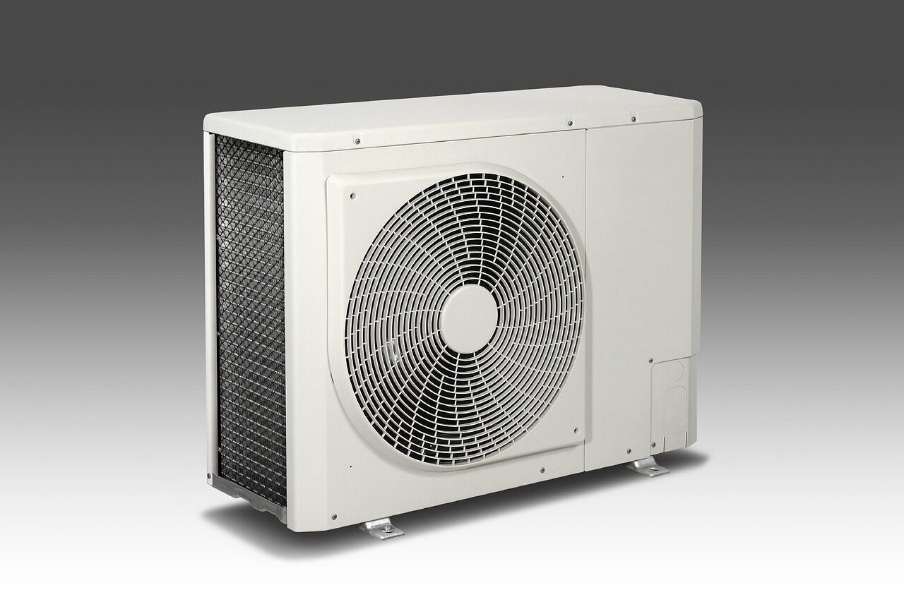 HVAC technician installing air conditioning unit